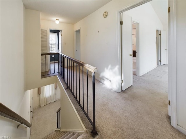 hall featuring light colored carpet