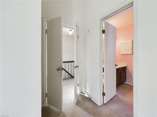 hallway featuring light carpet