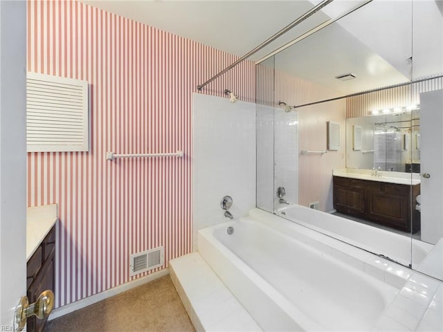 bathroom with vanity and tiled shower / bath