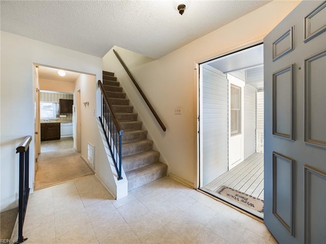 entrance foyer with a textured ceiling