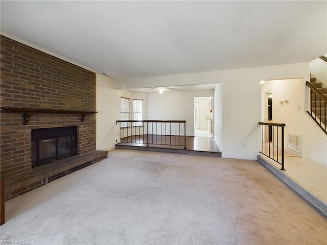 unfurnished living room featuring a fireplace and carpet