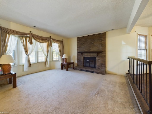 living room with beam ceiling, a fireplace, and light carpet