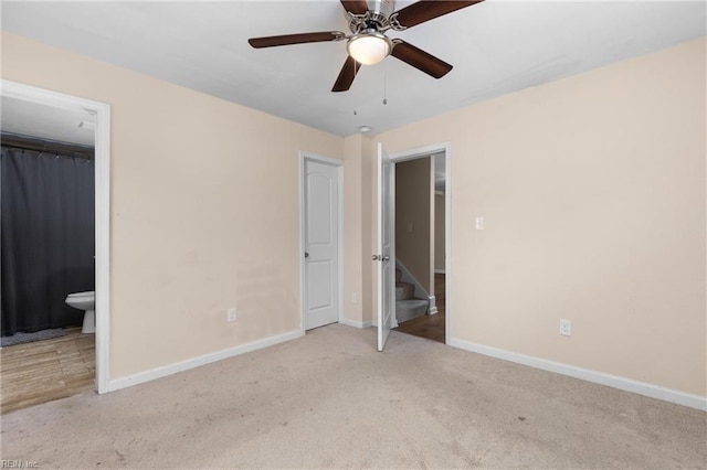 unfurnished bedroom with light carpet, a closet, ensuite bathroom, and ceiling fan