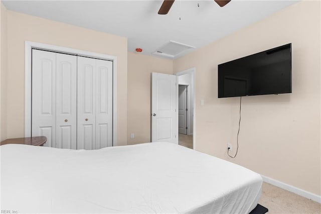 bedroom with ceiling fan, light colored carpet, and a closet