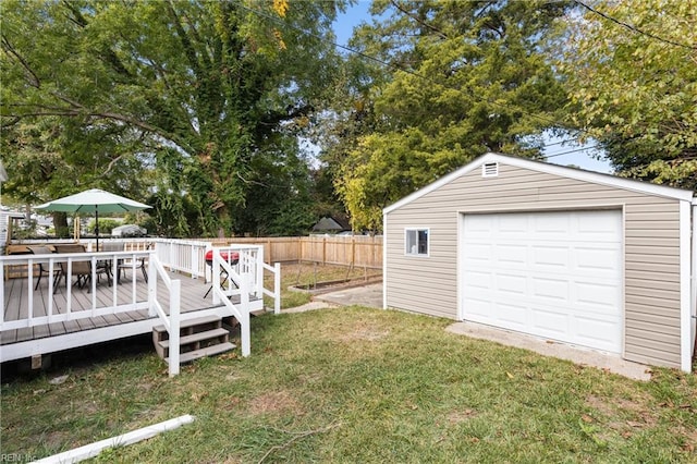 view of yard with an outbuilding, a garage, and a wooden deck