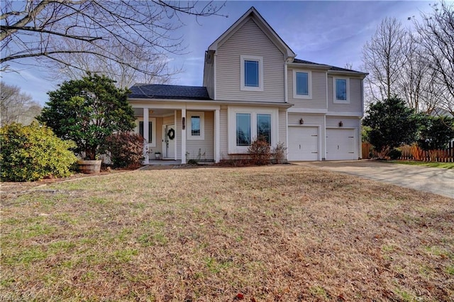 view of property with a front yard and a garage