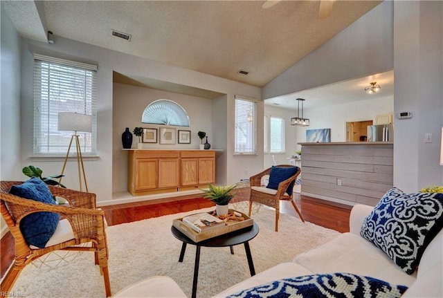 living room with light hardwood / wood-style flooring and vaulted ceiling