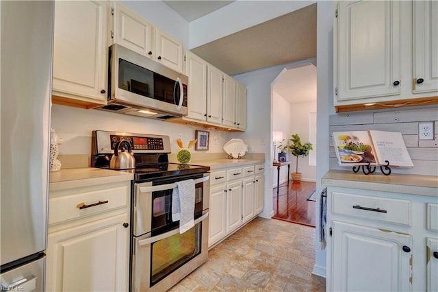 kitchen featuring white cabinets and appliances with stainless steel finishes