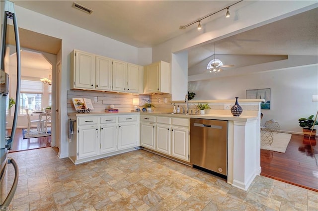 kitchen featuring sink, stainless steel dishwasher, kitchen peninsula, lofted ceiling, and ceiling fan with notable chandelier