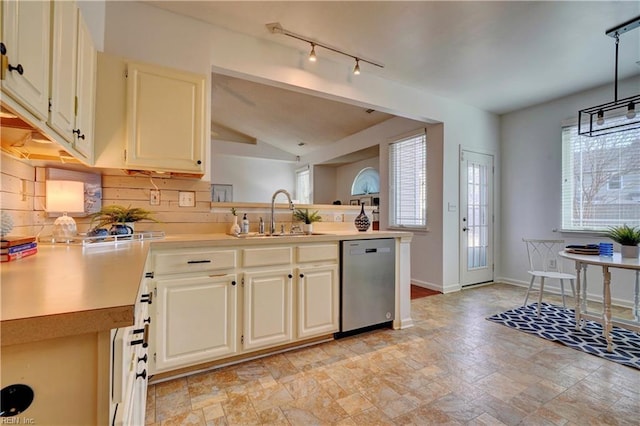 kitchen featuring decorative backsplash, stainless steel dishwasher, a healthy amount of sunlight, sink, and hanging light fixtures