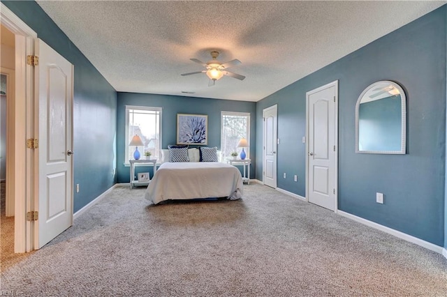 carpeted bedroom featuring a textured ceiling and ceiling fan