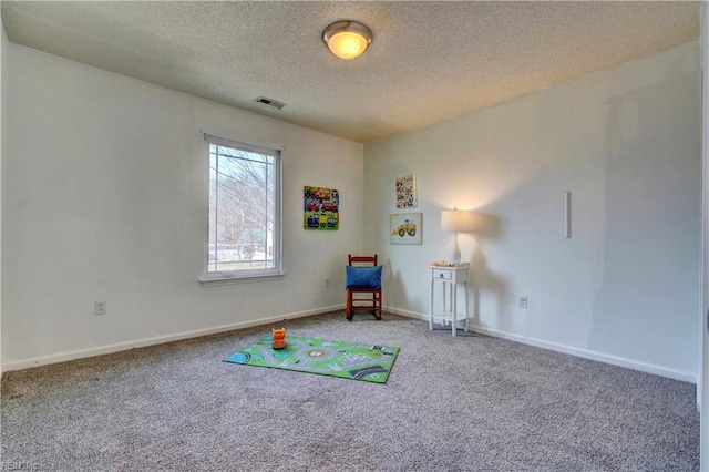 rec room featuring carpet floors and a textured ceiling