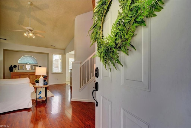 entrance foyer with ceiling fan, hardwood / wood-style floors, and vaulted ceiling