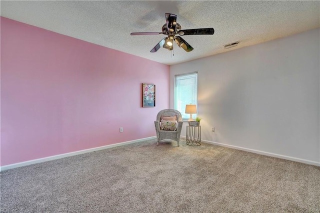 unfurnished room featuring carpet, ceiling fan, and a textured ceiling