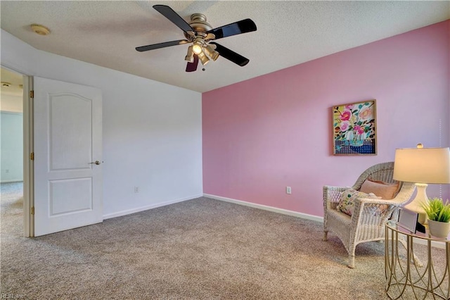 living area featuring ceiling fan and carpet