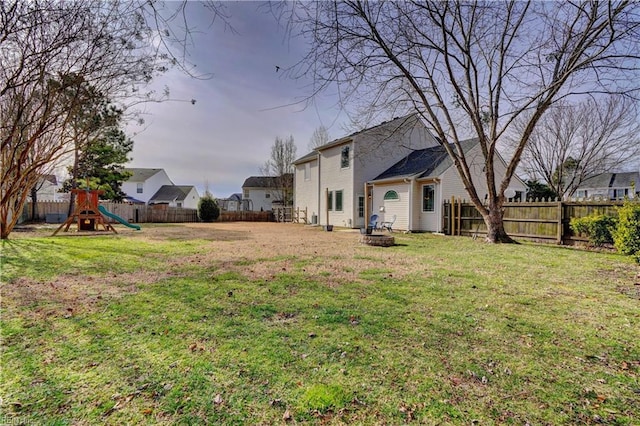 view of yard featuring a playground and a fire pit