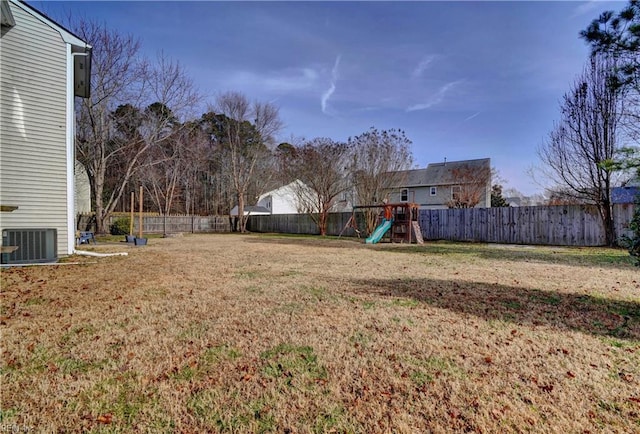 view of yard with a playground and central AC unit