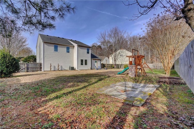 view of yard featuring a patio and a playground