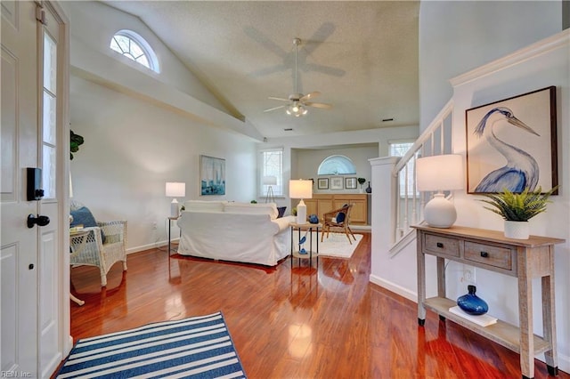 bedroom with wood-type flooring, vaulted ceiling, multiple windows, and ceiling fan