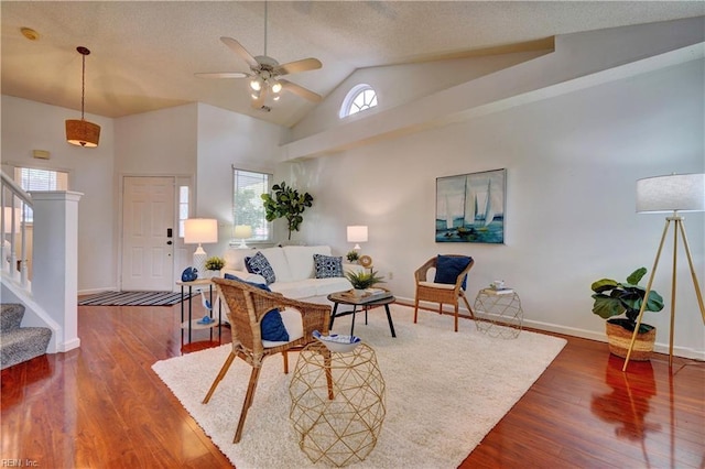 living room featuring ceiling fan, wood-type flooring, and high vaulted ceiling