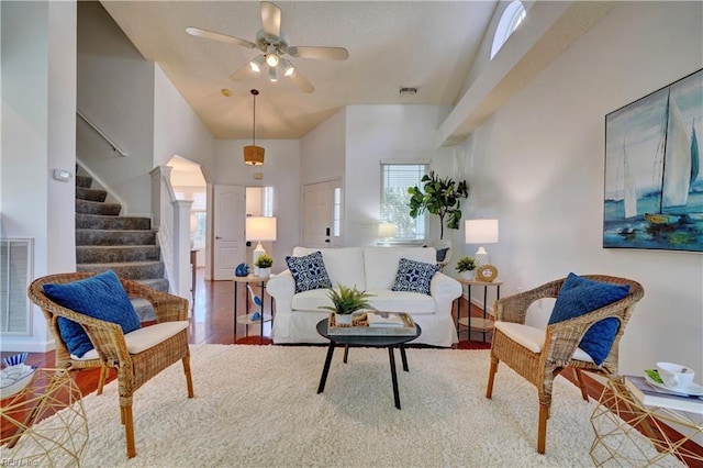 living room with wood-type flooring, high vaulted ceiling, a wealth of natural light, and ceiling fan