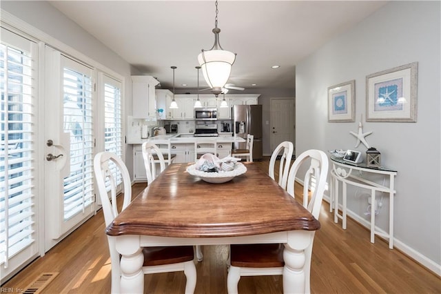 dining space with light hardwood / wood-style floors