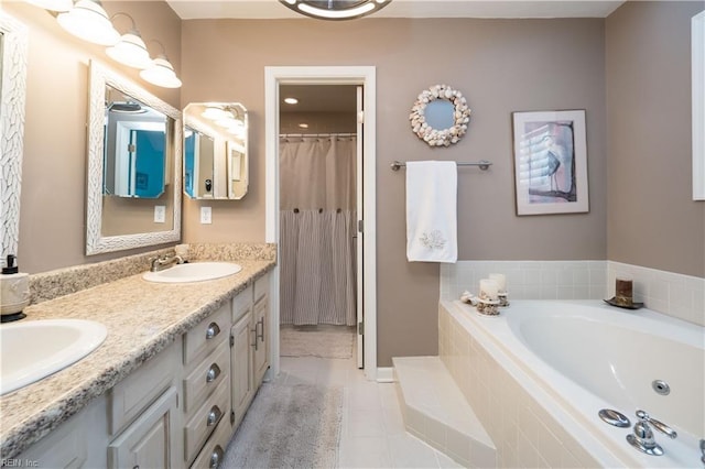 bathroom featuring vanity, tile patterned flooring, and a relaxing tiled tub