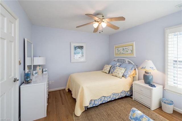 bedroom with ceiling fan and light wood-type flooring