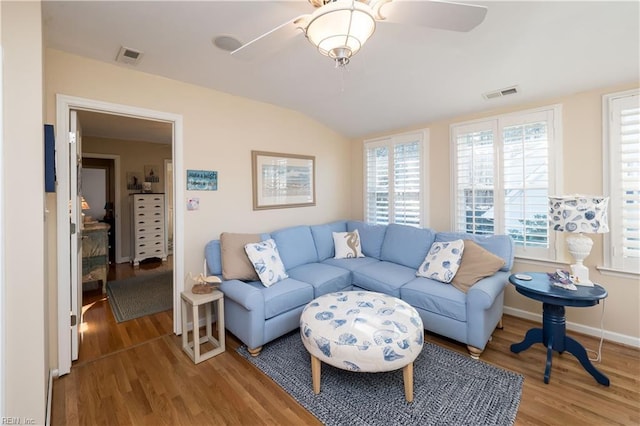 living room featuring hardwood / wood-style flooring, ceiling fan, and lofted ceiling