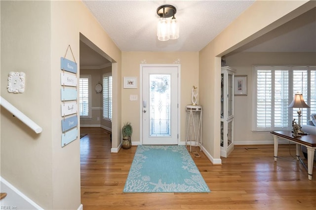 foyer featuring wood-type flooring and a textured ceiling