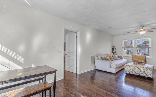 living room with ceiling fan and dark hardwood / wood-style floors