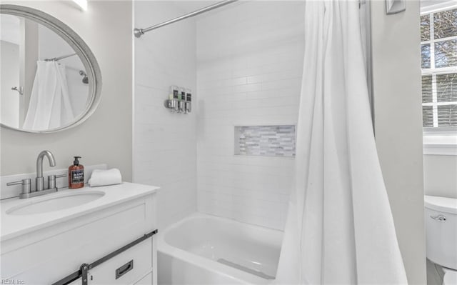 full bathroom featuring shower / bath combination with curtain, vanity, and toilet