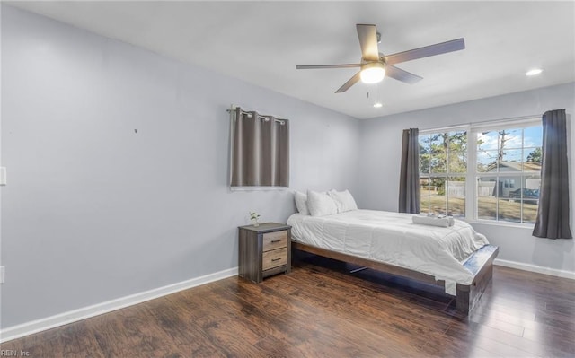 bedroom featuring ceiling fan and dark hardwood / wood-style floors