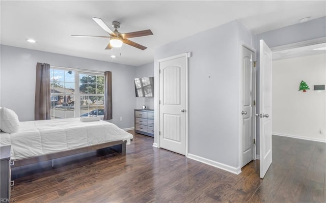 bedroom with dark hardwood / wood-style flooring and ceiling fan