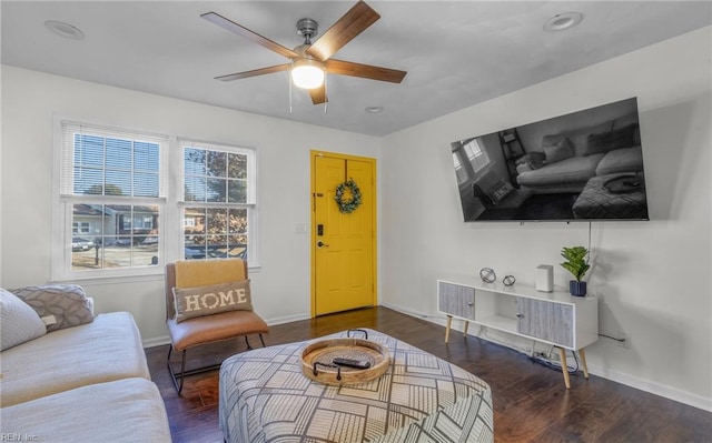 living room with dark hardwood / wood-style flooring and ceiling fan