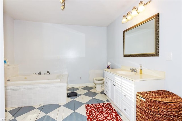 bathroom featuring vanity, toilet, and tiled bath