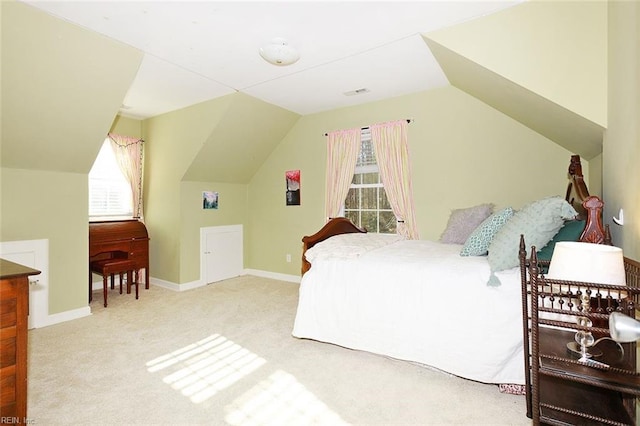 carpeted bedroom featuring lofted ceiling