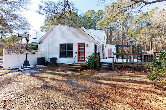 back of property featuring central air condition unit and a wooden deck