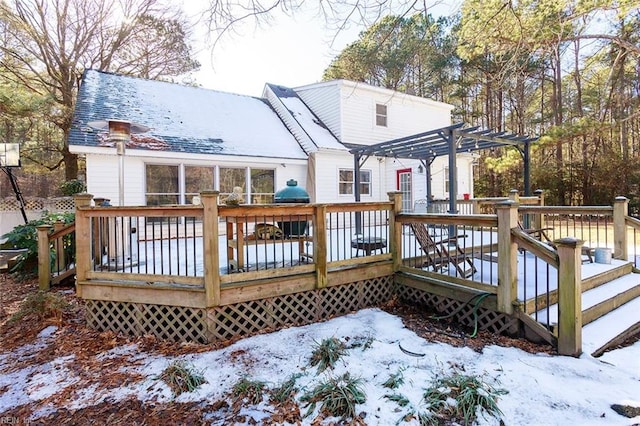 snow covered deck featuring a pergola