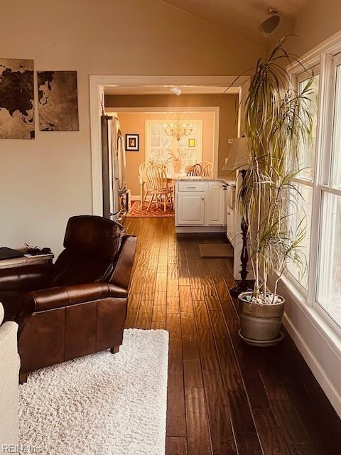 living room with dark hardwood / wood-style flooring and lofted ceiling