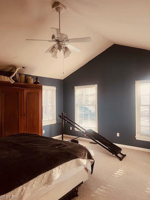 unfurnished bedroom featuring carpet, vaulted ceiling, and ceiling fan