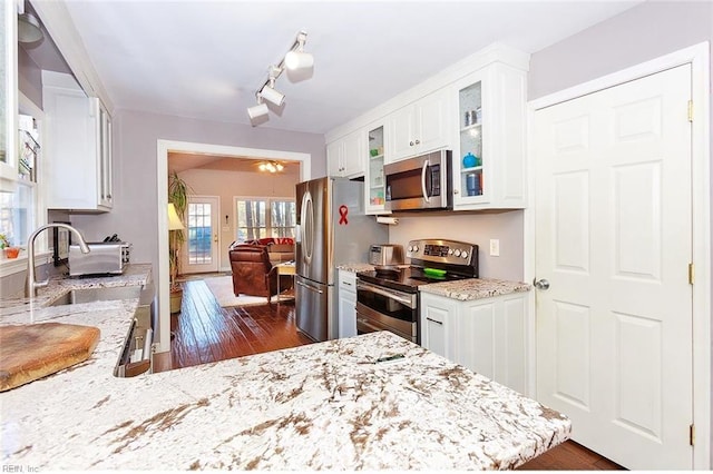 kitchen featuring light stone counters, white cabinetry, and appliances with stainless steel finishes