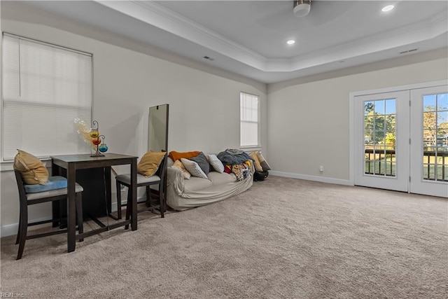 interior space with ceiling fan, crown molding, and a tray ceiling