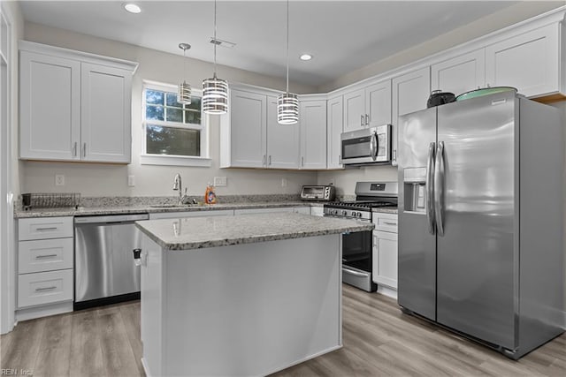 kitchen with a center island, white cabinetry, and appliances with stainless steel finishes