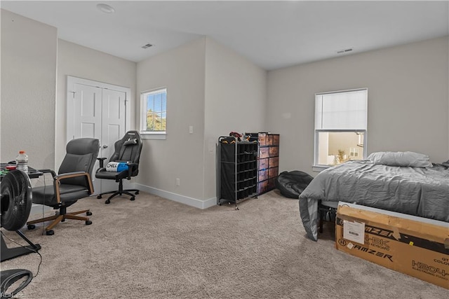 carpeted bedroom with a closet