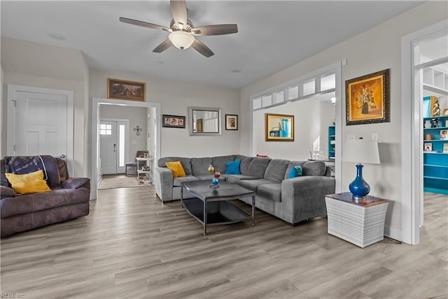 living room featuring light hardwood / wood-style flooring and ceiling fan