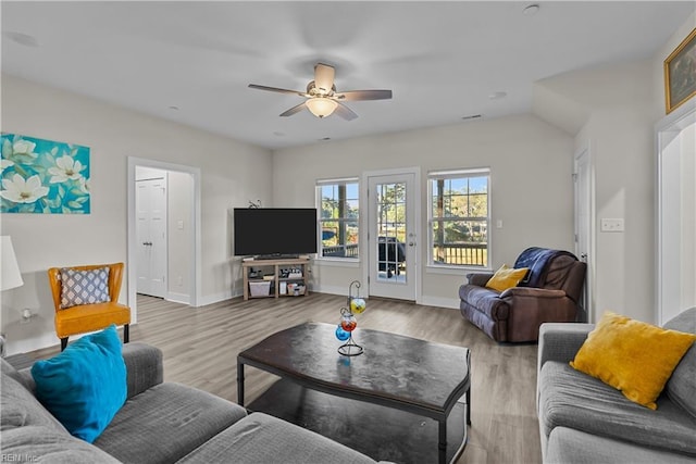 living room featuring ceiling fan and light hardwood / wood-style flooring