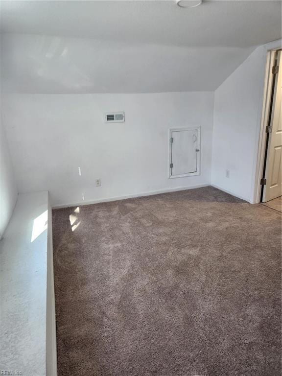 empty room with carpet and lofted ceiling