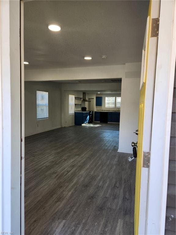 unfurnished living room featuring dark wood-type flooring