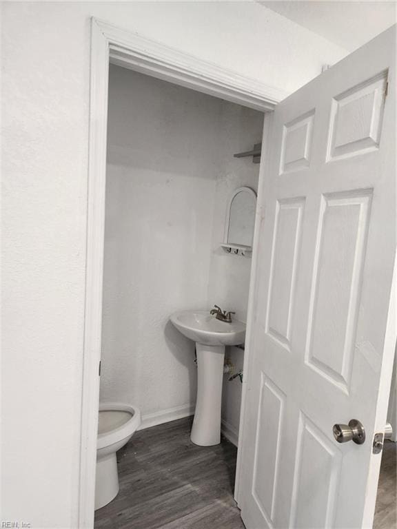 bathroom with wood-type flooring and toilet